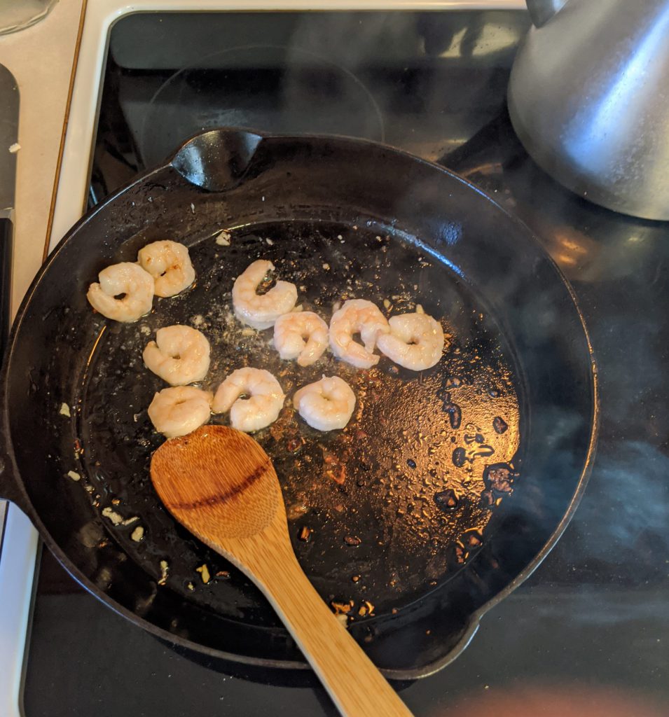 shrimp cooking in cast iron pan