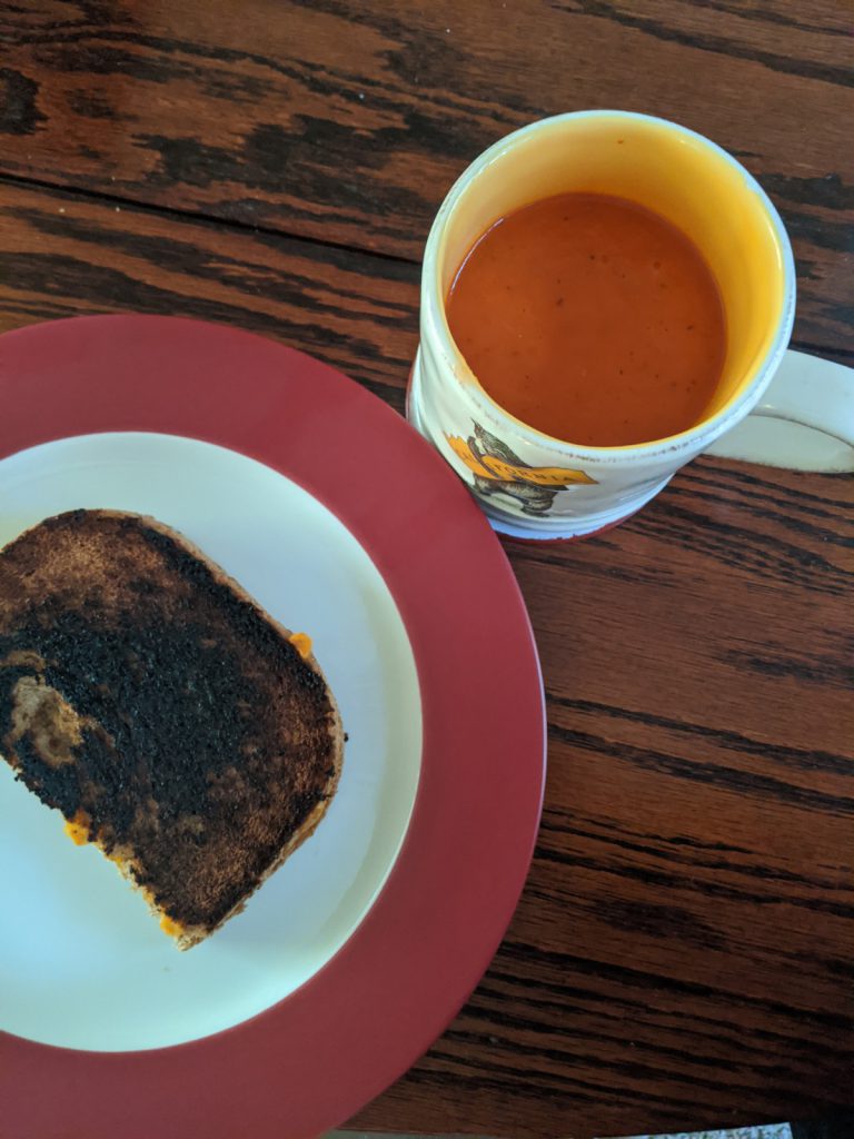 grilled cheese and tomato soup in a mug