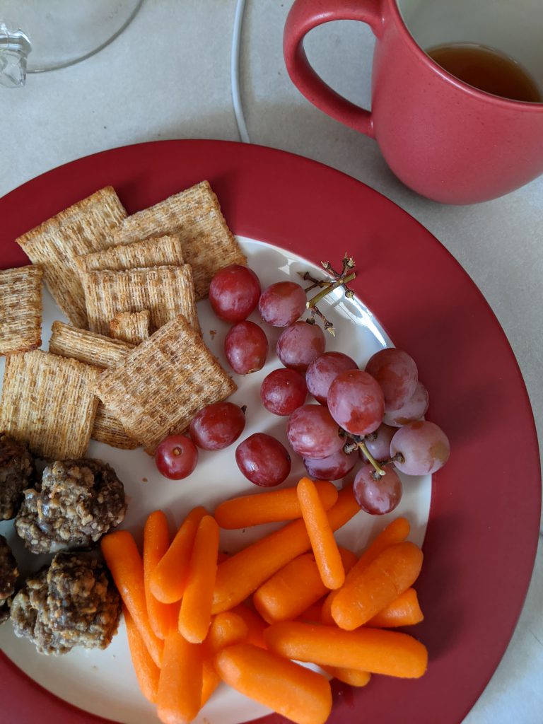 plate with crackers, meatballs, grapes, carrots