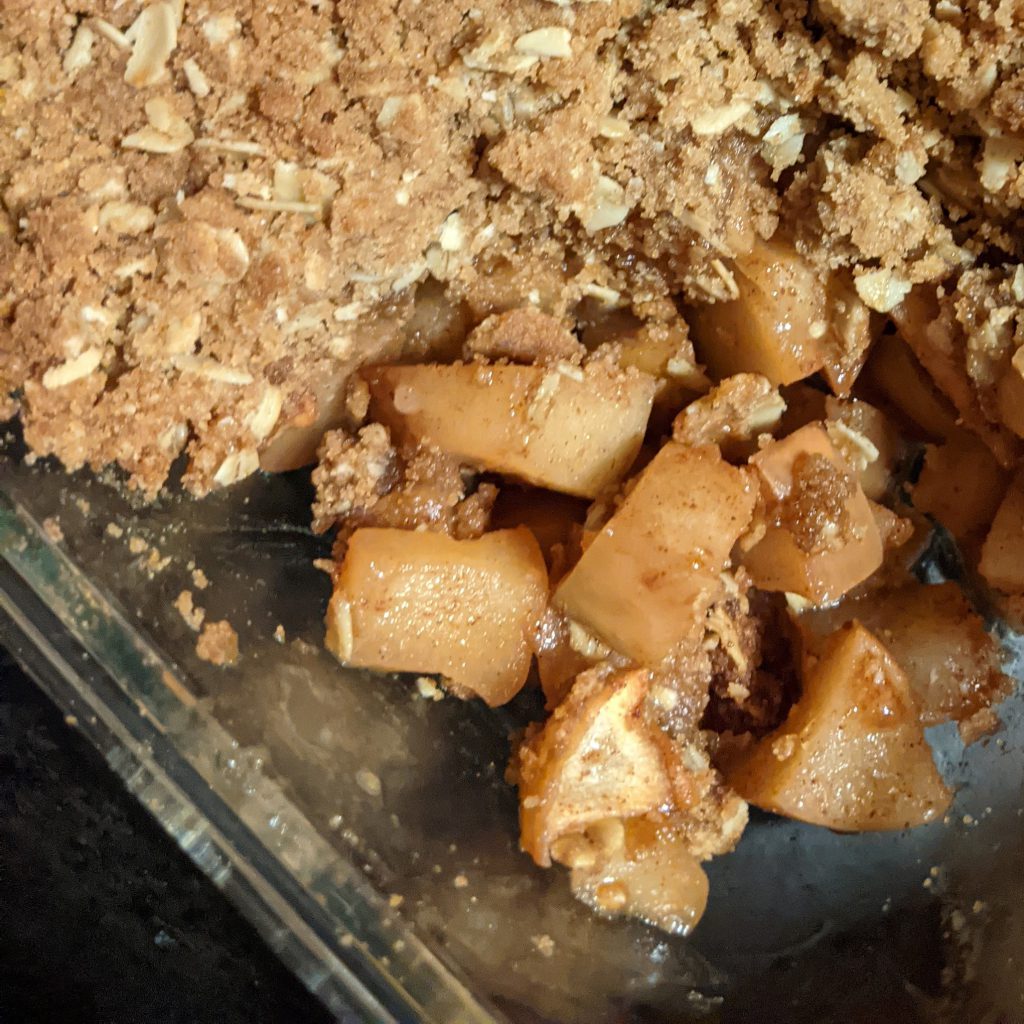 close up of apple crisp in a glass dish