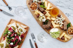 sliced bread with sliced vegetables on brown wooden chopping board