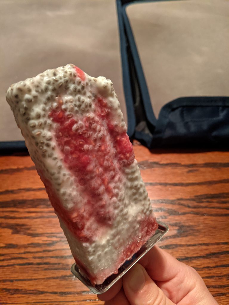 A pink and white ice pop full of chia seeds