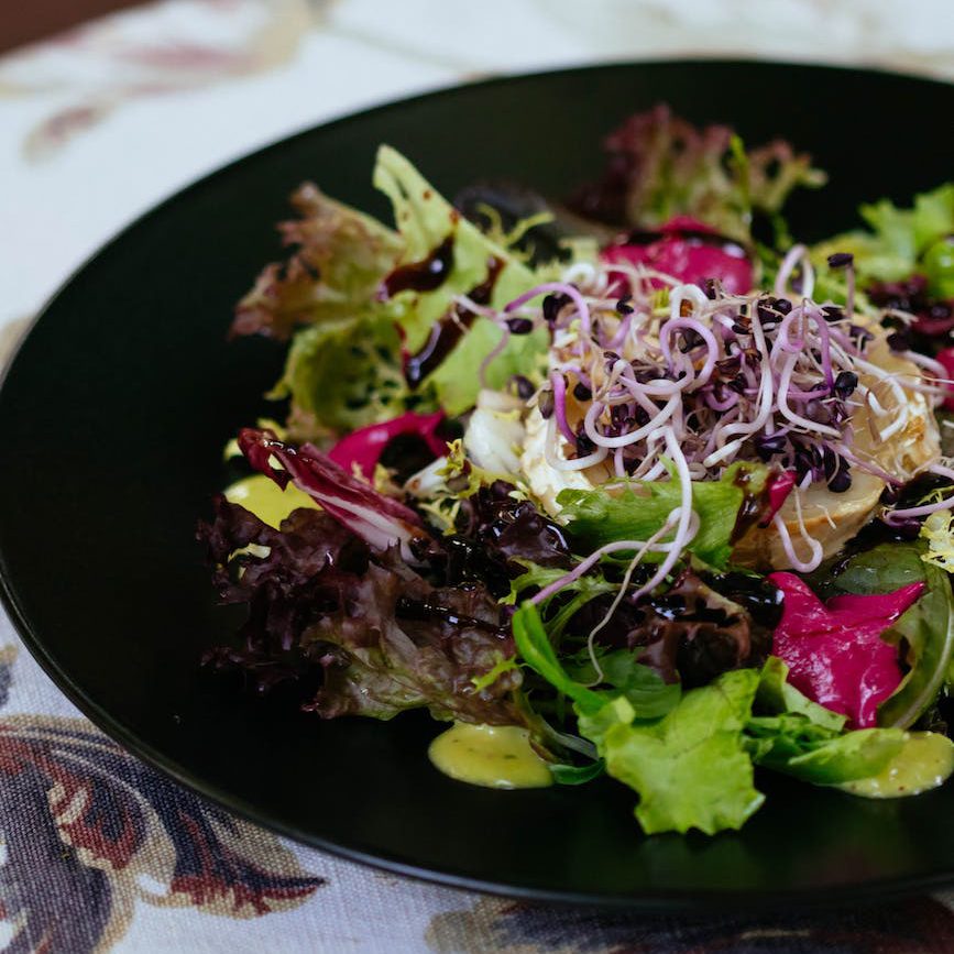 mixed vegetable salad on a black plate