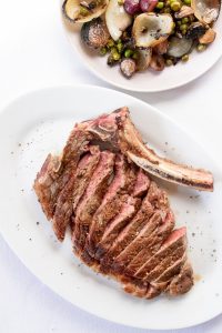 yummy cut steak served on table in light restaurant
