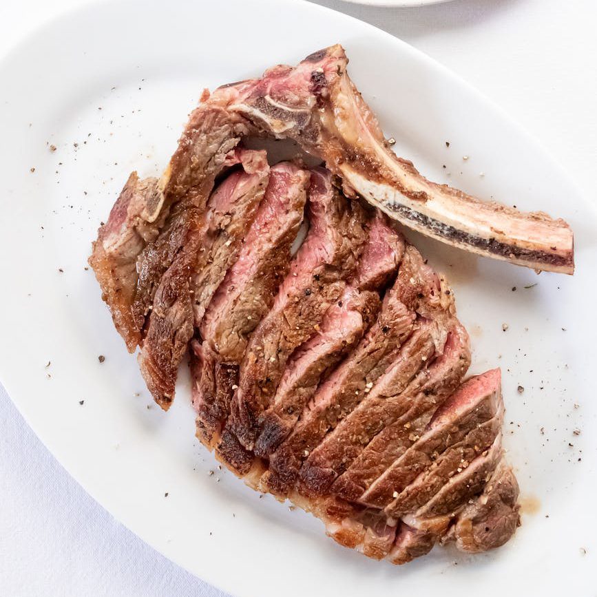 yummy cut steak served on table in light restaurant